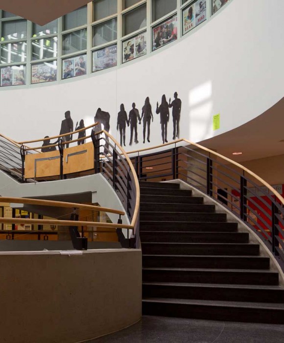 A group of people standing on top of stairs.