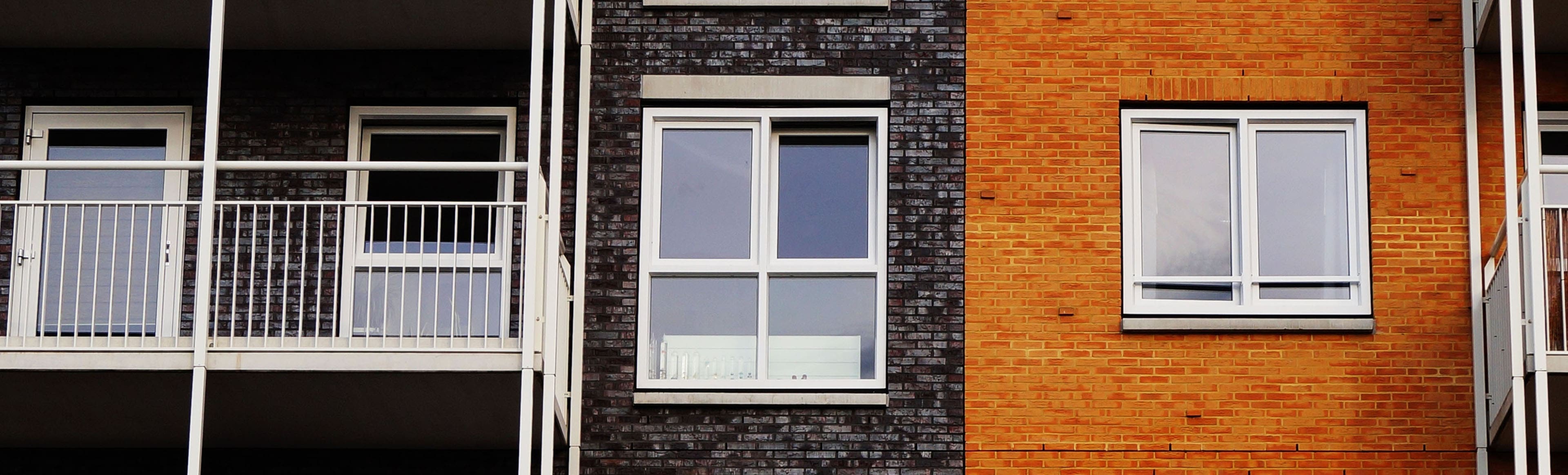 A window in the middle of a brick wall.