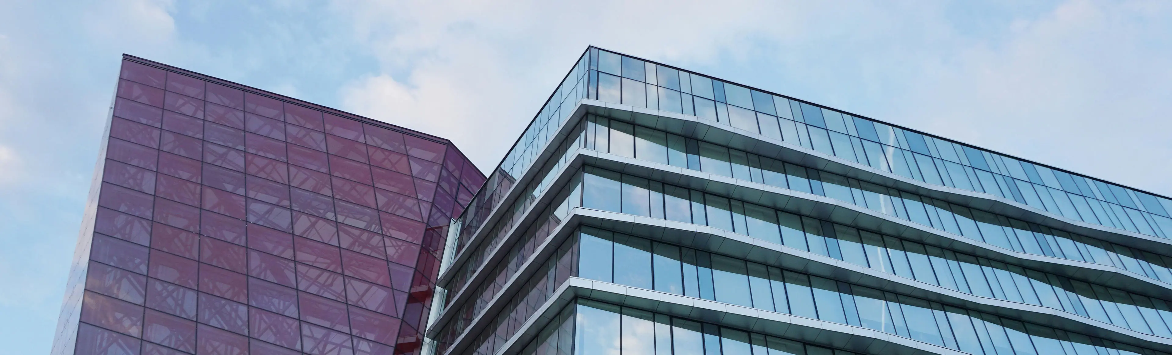 A building with many windows and glass on the outside.